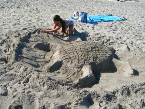 Trynity working on her turtle sand sculpture